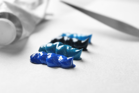 Colorful oil paints on white paperの写真素材