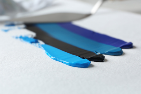 Oil paint strokes on white paperの写真素材