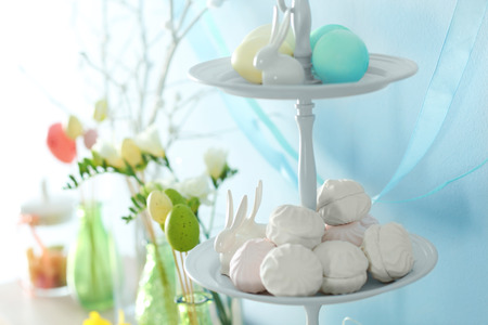 Stand with meringues and painted eggs, closeup