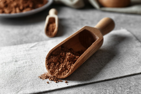 Wooden scoop with cocoa powder on napkinの写真素材