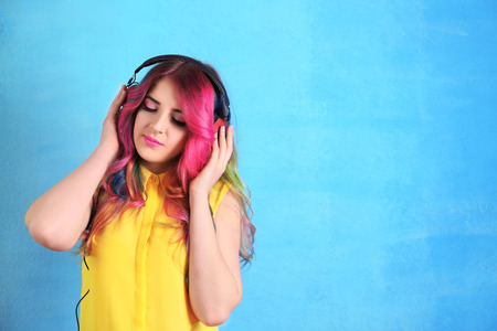 Trendy hairstyle concept. Young woman with colorful dyed hair on color backgroundの写真素材