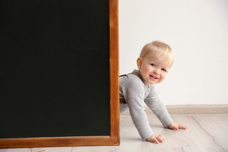 Cute little boy and blackboard indoorsの写真素材
