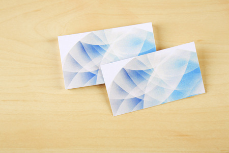 Blank paper cards for branding on wooden background