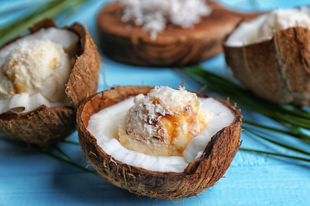 Halves of coconut with fresh ice cream on color backgroundの写真素材