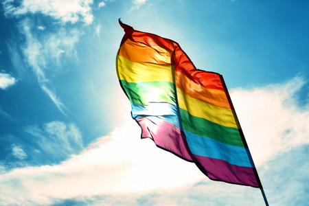 Gay flag on sky background