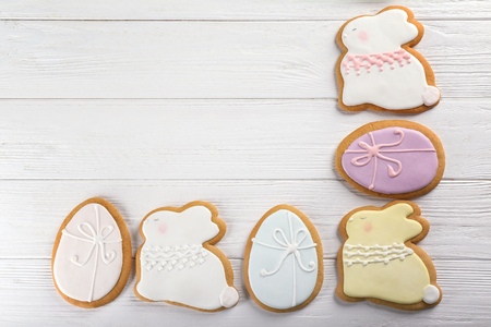 Beautiful glazed Easter cookies on wooden table