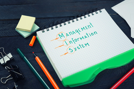 Notebook and stationery on dark wooden table. Management conceptの写真素材