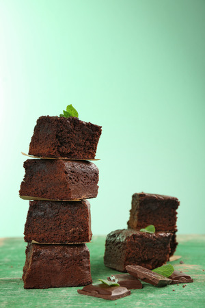 Pieces of delicious chocolate brownie on wooden tableの写真素材