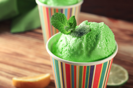 Tasty green ice cream on wooden backgroundの写真素材