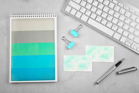 Business cards, computer and stationery on light tableの写真素材