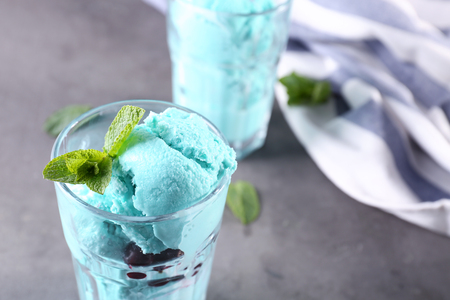 Tasty color ice cream with mint on tableの写真素材