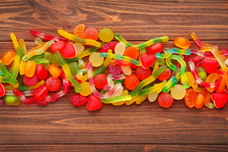 Tasty and colorful jelly candies on wooden backgroundの写真素材