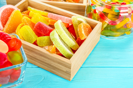 Composition of tasty jelly candies on wooden background, closeupの写真素材