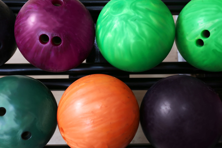 Colorful balls on rack in bowling clubの写真素材