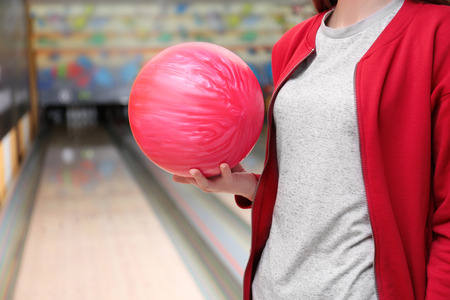 Young woman with ball in bowling club, closeupの写真素材