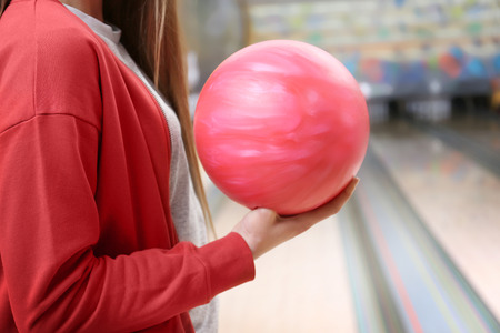 Young woman with ball in bowling club, closeupの写真素材