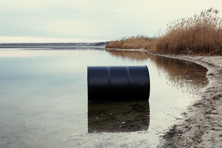 Big black barrel on beach. Environment pollution conceptの写真素材