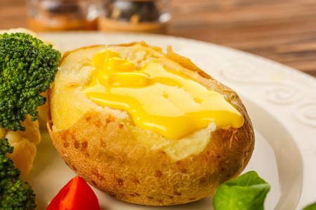 Baked potato with cheese sauce, closeupの写真素材