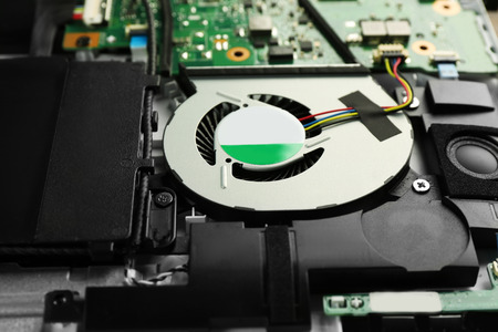 Cooling system in dismantled laptop, closeup. Concept of computer repair