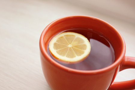 Cup of hot tea with lemon on wooden background, closeupの写真素材