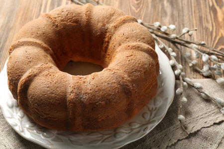 Plate with tasty Easter cake on table