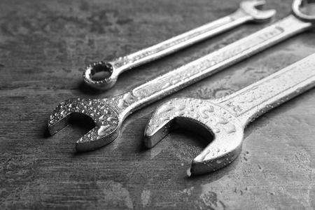 Combination wrenches and spanner on wet tableの写真素材