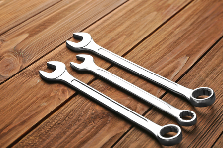Combination wrenches on wooden backgroundの写真素材