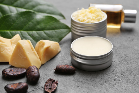 Beautiful composition with ingredients for cocoa butter lotion on tableの写真素材