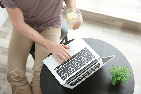 Young man working with laptop at homeの写真素材