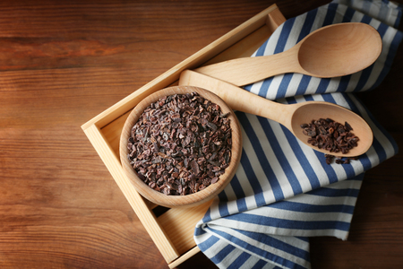Composition with cocoa nibs on wooden tableの写真素材