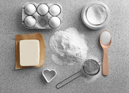 Ingredients for preparing butter cookies on kitchen tableの写真素材