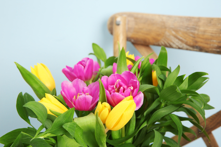 Bouquet of beautiful tulips on chairの写真素材