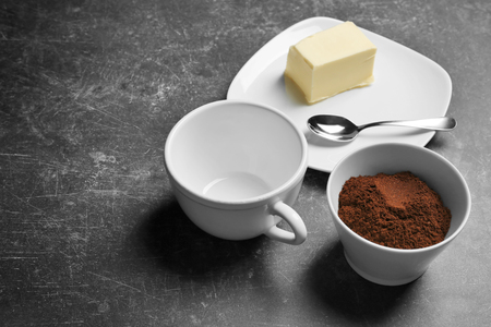 Ground coffee and butter on gray backgroundの写真素材