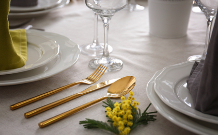 Cutlery set and floral decoration on tableの写真素材
