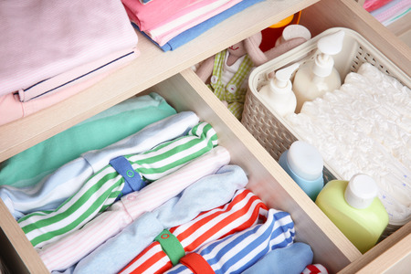 Wardrobe with clothes and necessities in baby roomの写真素材