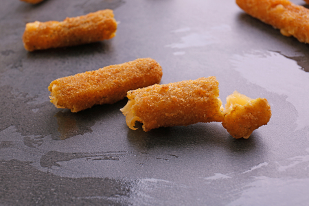 Delicious fried cheese sticks on grey backgroundの写真素材
