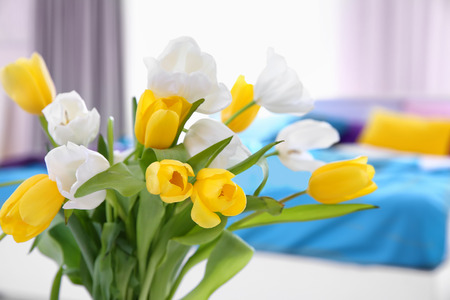 Bouquet of white and yellow tulips in light roomの写真素材