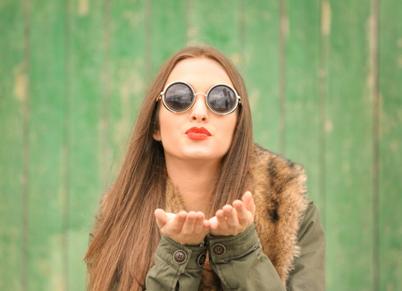 Beautiful young woman with bright on color backgroundの写真素材