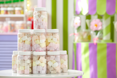 Tasty marshmallow in jars at candy shopの写真素材