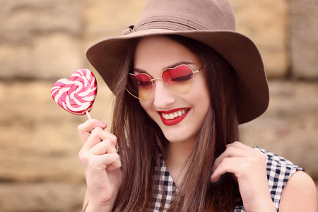 Beautiful young woman with bright lips on blurred backgroundの写真素材