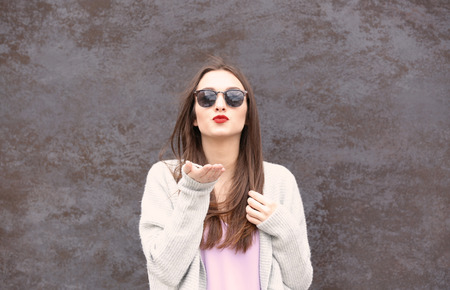 Beautiful young woman with bright lips on textured backgroundの写真素材