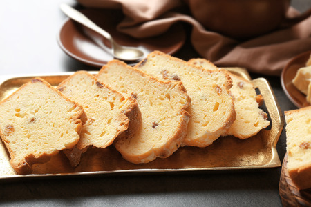 Tray with delicious sliced butter cake on  tableの写真素材