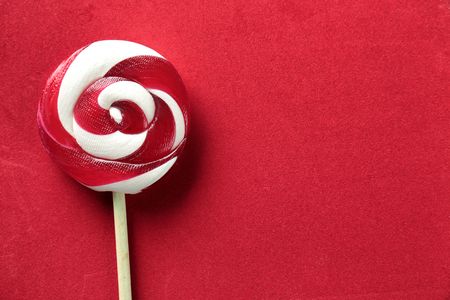 Tasty spiral candy on color backgroundの写真素材