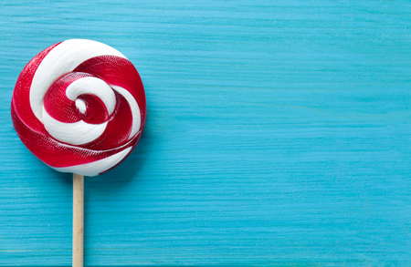 Tasty colorful candy on wooden backgroundの写真素材