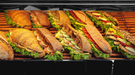 Fridge with bakery products in shop, closeup