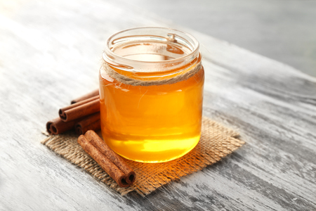 Cinnamon and honey in jar on tableの写真素材