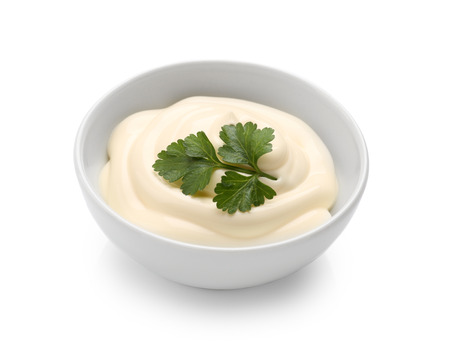 Delicious mayonnaise with parsley in bowl isolated on whiteの写真素材