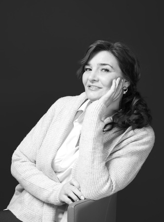 Beautiful elderly woman posing on black backgroundの写真素材