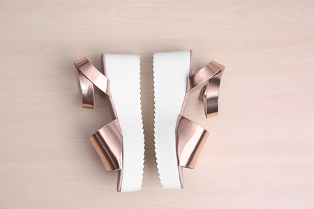 Female stylish shoes on wooden backgroundの写真素材