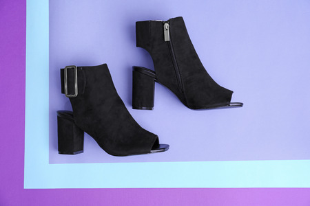 Female stylish shoes on color backgroundの写真素材